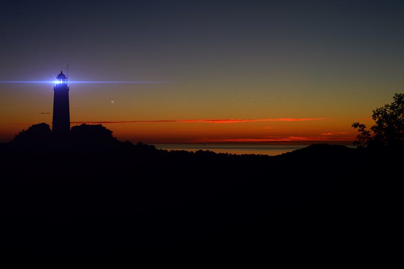 A path illuminated by light amidst darkness.