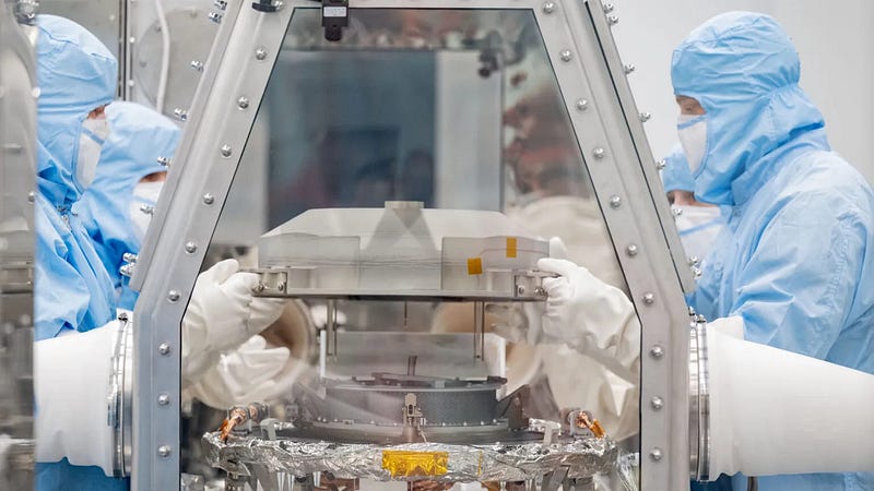 Researchers examining the Bennu sample in a clean room