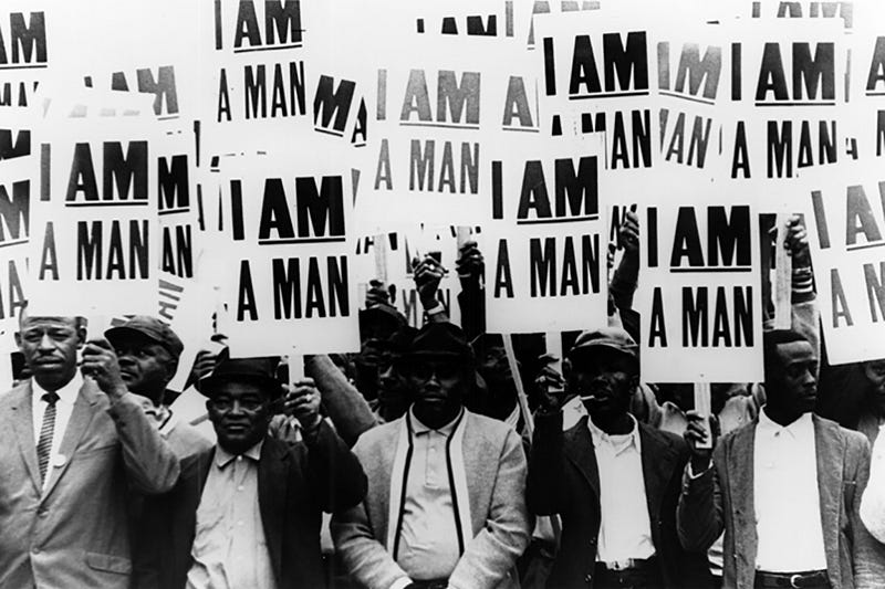 Strikers hold placards during the civil rights movement