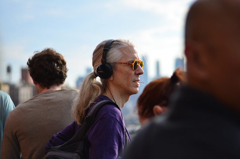 A person in a purple shirt, oblivious to being watched.